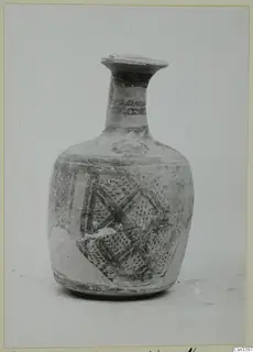 Bichrome wheel-made pottery vessel with a long neck, painted dark bands and lattice patterns on the body