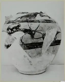 Pottery Bichrome Wheel-made vessel with black painted bands and a large curving motif