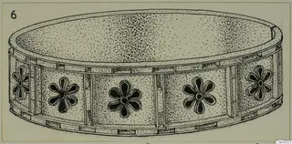 Field drawing of a shallow gold object with flower-like rosettes around its side