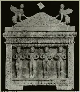 Limestone sarcophagus from Cyprus with four standing relief figures and winged figures on its pediment