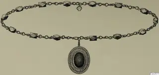 Drawing of a gold necklace with faceted beads and an oval pendant with a leaf-pattern border