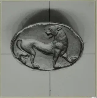 Oval object with a raised relief of an animal standing in profile, facing right