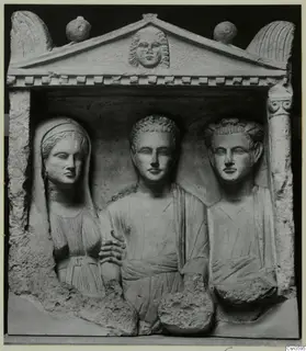 Limestone relief of three busts in a pedimented niche, with a veiled woman on the left and two men beside her.