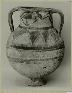 Painted two-handled jar with a footed base and black bands and linear motifs on a pale surface