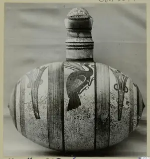 Pottery Bichrome IV jug with a tall neck, a dark bird-like motif and vertical striped bands on the body