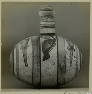 Pottery Bichrome IV jug with a large painted bird and vertical bands, photographed on a stand
