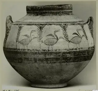 Bichrome IV jug with two handles, painted with long-necked birds between palm-like motifs and horizontal bands.
