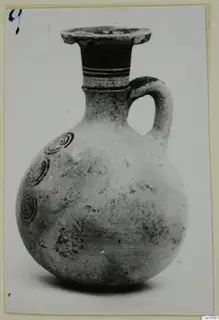 Pottery Bichrome IV jug with a single loop handle and concentric circle motifs on the body