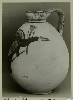 Pottery Bichrome IV jug with a painted bird and flower, number 754 on the body