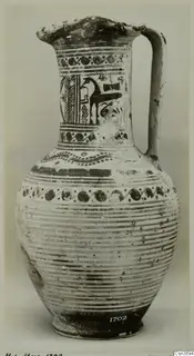 Jug with a flaring mouth and strap handle, painted with dark bands and a horse-like animal on the neck.