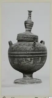 Painted pottery vessel with a tall stacked knob on its lid, a side spout, two loop handles and a ring foot