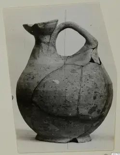 Jug with a round body, strap handle and broken flaring mouth, from Marion tombs 31–45