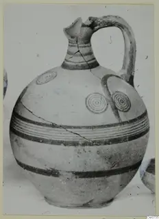 Pottery Bichrome V jug with a single handle, painted bands and concentric circles on the body