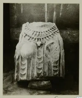 Stone statue fragment from Arsos, carved with a collar of pendant drops and curved relief bands