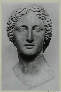 Sculpted stone head of a woman with wavy hair, shown as a bust with the shoulders