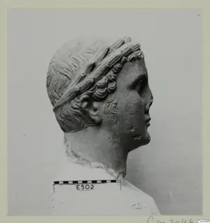 Sculpted head and upper bust in profile, facing right, with a wide band wound through the hair