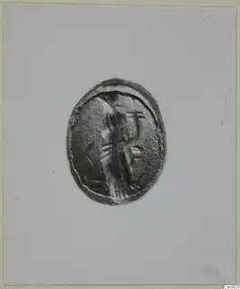 Oval engraved seal or gem showing a standing figure, photographed face-on