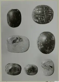 Seven oval seals and gems in three rows, one with an incised cross-hatched pattern on its flat face
