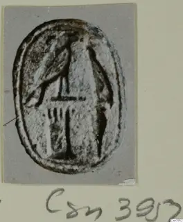 Oval seal or gem with an incised linear design, photographed on a grey card