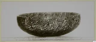 Blown glass bowl with a mottled marbled pattern, shown in side view.
