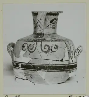 Painted pottery jug with a tall flaring neck, strap handle and spiral motifs on the shoulder, from the Cyprus Museum