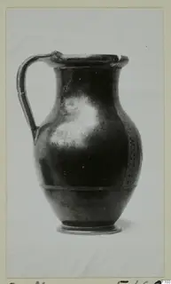 Dark glossy jug with a single strap handle and a low ring foot