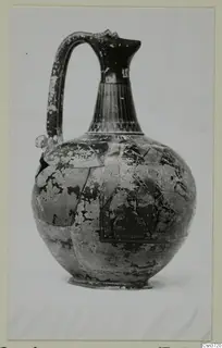 Globular jug with a tall fluted neck and strap handle, shown against a pale background