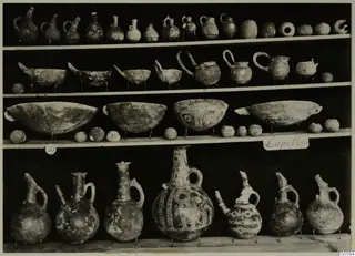 Jugs, bowls and round vessels displayed on wooden shelves, from Lapithos Markides T.50