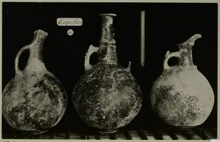 Three round-bodied jugs with side loop handles and tall necks, photographed side by side against a black background, from Lapithos Markides.