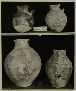 Four pottery vessels from Lapithos Markides Tomb 50 on two shelves, two small jugs above and two large jars below.