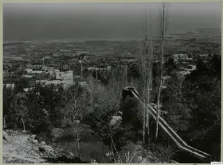 View down over the village of Lapithos, with buildings, cultivated fields and the sea beyond