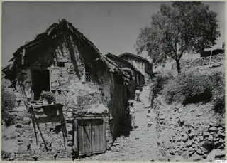 Stone-built houses and a cobbled lane climbing through the village of Lazania