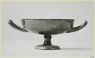 Two-handled footed bowl of black-glazed ware, photographed in side view