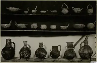Three shelves of painted pottery vessels, bowls and jugs with geometric patterns, from Cyprus, Cyprus Museum.