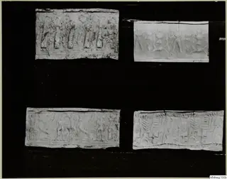 Four rectangular pieces, each with raised figures and patterns carved in horizontal bands, set on a black backing