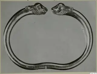 Heavy metal ring with two animal heads facing each other across the gap, from Vouni