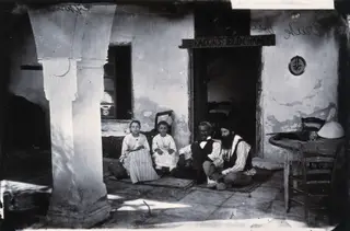 A family seated in a courtyard, 1981 contact print
