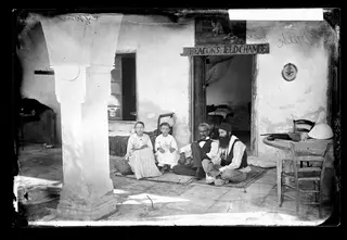 A family seated in a courtyard