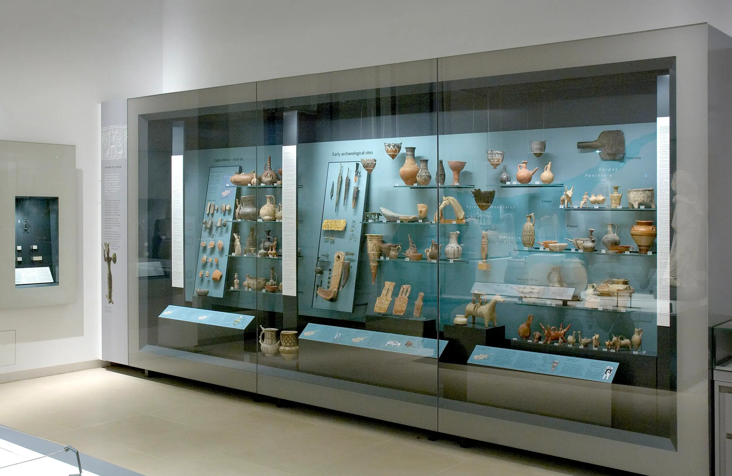 The Ashmolean's Cyprus case, where the two Brew planks stood on display from 1972 until 2025. Both stand in the lower middle of the case, beside a single-headed plank figure belonging to the museum itself. (Ashmolean Museum, Oxford)