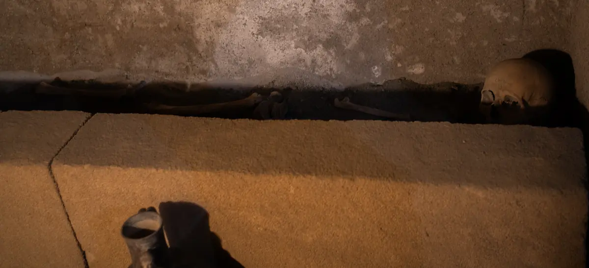 Figure 11: 5th Century B.C. rock-cut tomb in square burial chamber, human remains.