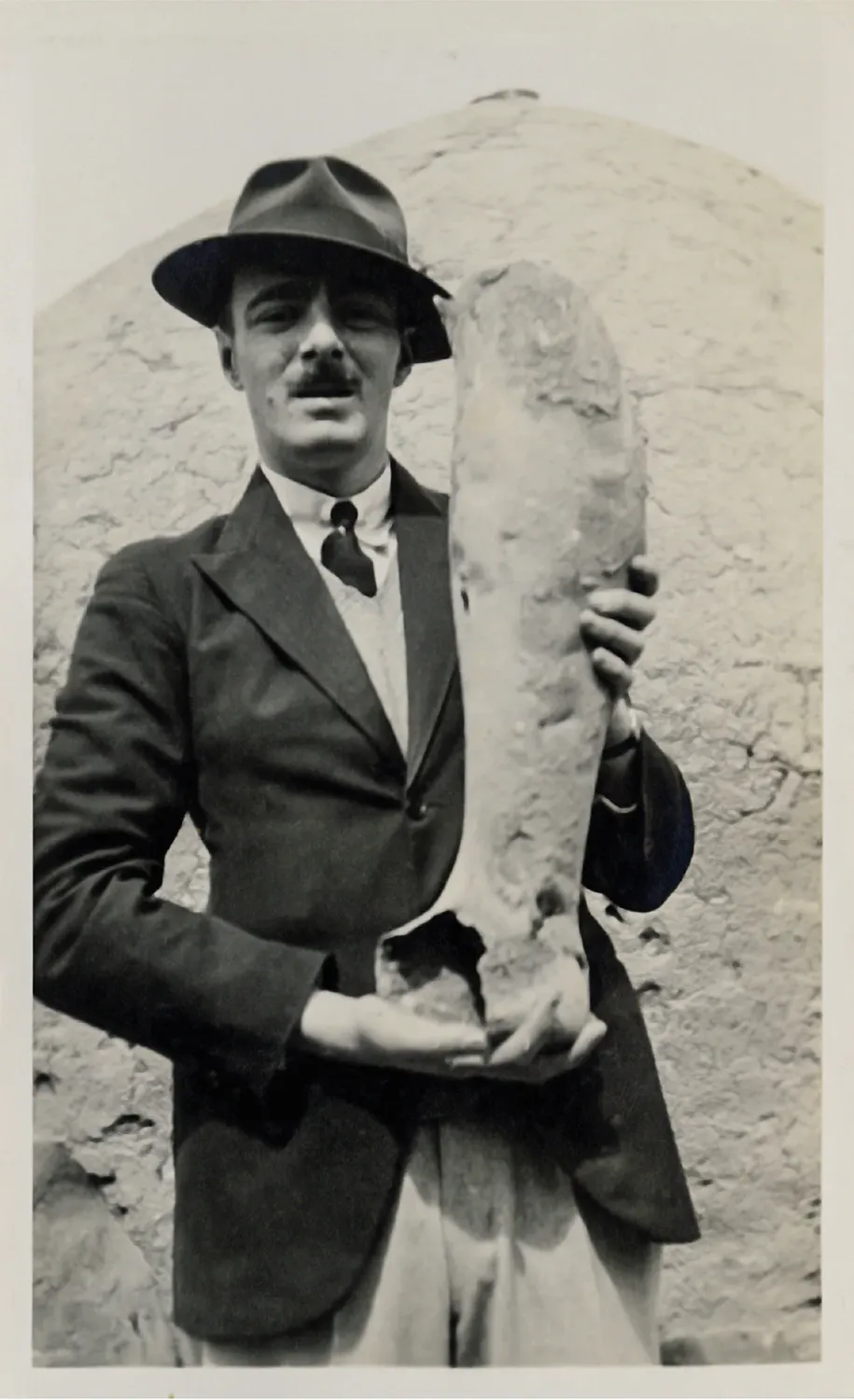 Rupert Gunnis cradling a fragment of the bronze statue of the emperor Septimius Severus from the Cyprus Museum. Photo from a Gunnis album. (Tunbridge Wells Borough Council t/a The Amelia.)