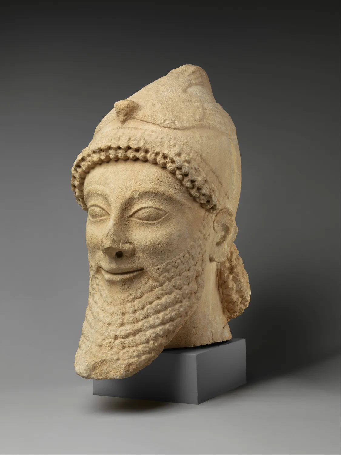 Cypriot limestone votary head, Archaic, last quarter of the 6th century BCE. The Metropolitan Museum of Art, Cesnola Collection.