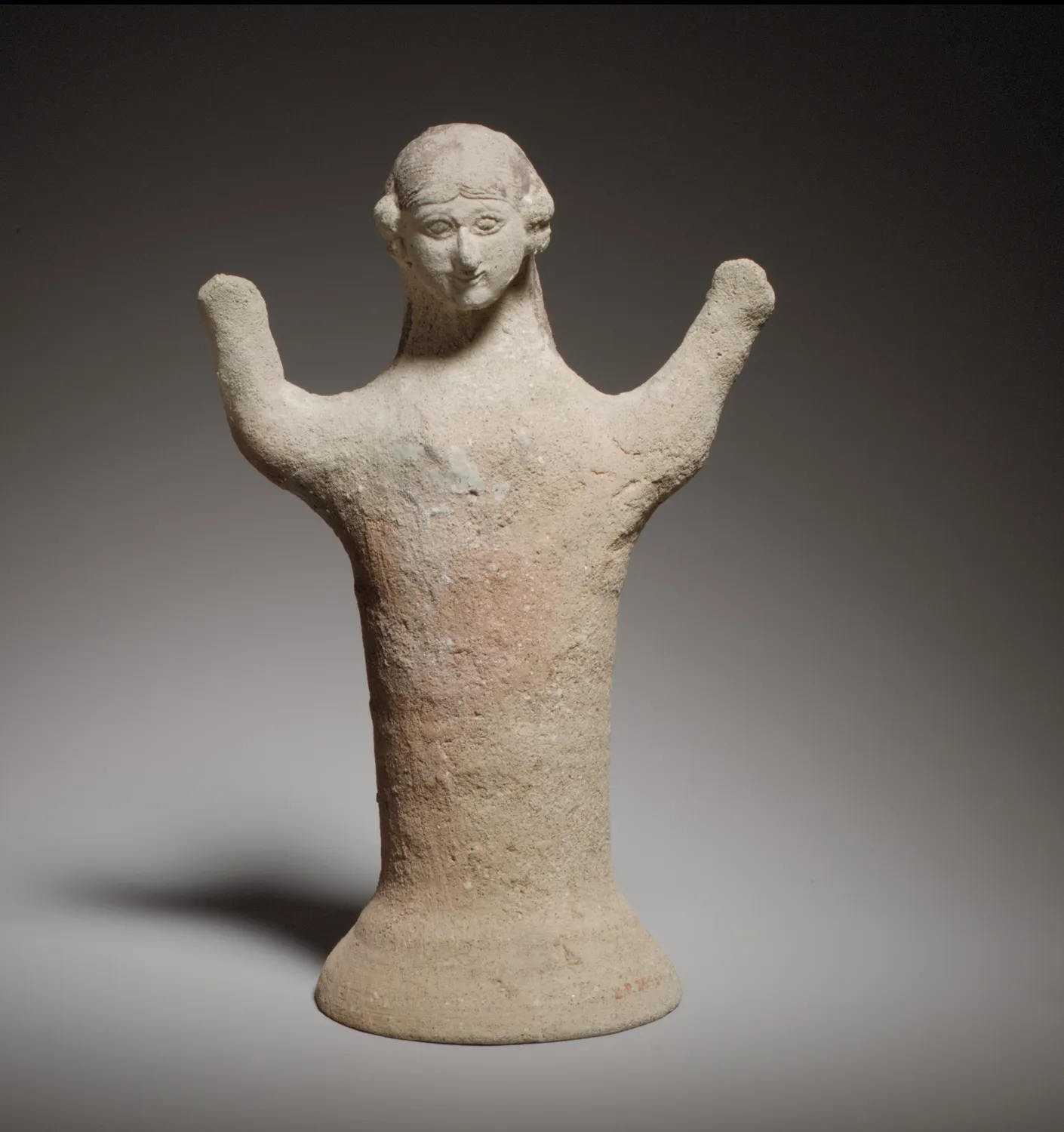 Cypro-Archaic terracotta figure of a woman with raised arms, red paint still showing on the body, on a flaring base. Metropolitan Museum of Art.