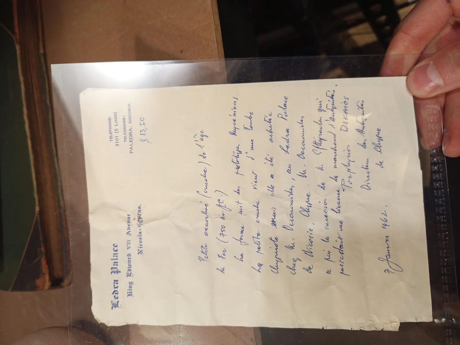 A handwritten letter in French on Ledra Palace hotel stationery, headed King Edward VII Avenue, Nicosia-Cyprus, describing a small Iron Age jug and signed Porphyrios Dikaios, Directeur des Antiquités de Chypre, dated 7 January 1962, with the value $13.50 noted at the top.