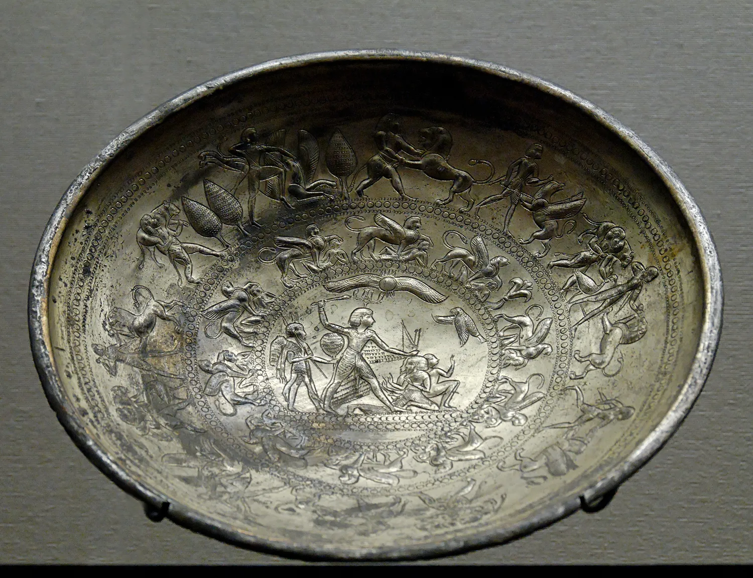 The silver bowl from Idalion, Louvre AO 20135, its interior worked in concentric registers of figures around a central scene of a hero mastering his enemies.