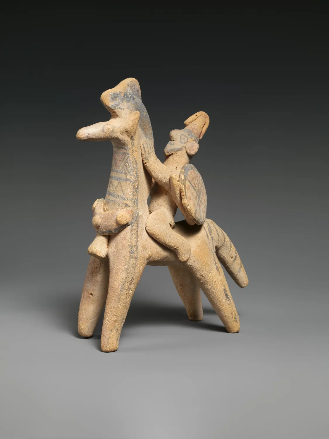 A Cypriot terracotta horseman with a round shield, about 600 BC, of the kind dug by the thousand at sanctuary sites. This one left the island in the Cesnola Collection and is now in the Metropolitan Museum of Art.