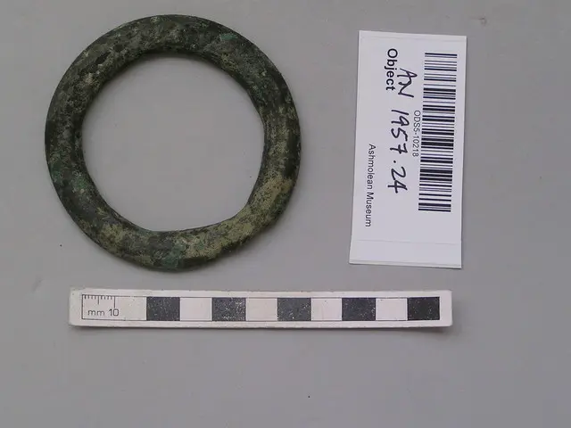 Solid copper ring ingot, round one side, flat on other, Early Bronze Age II Cypriot jewelry