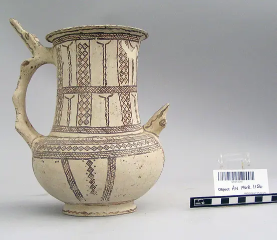 White Slip I tankard with animal head spur on handle and shoulder