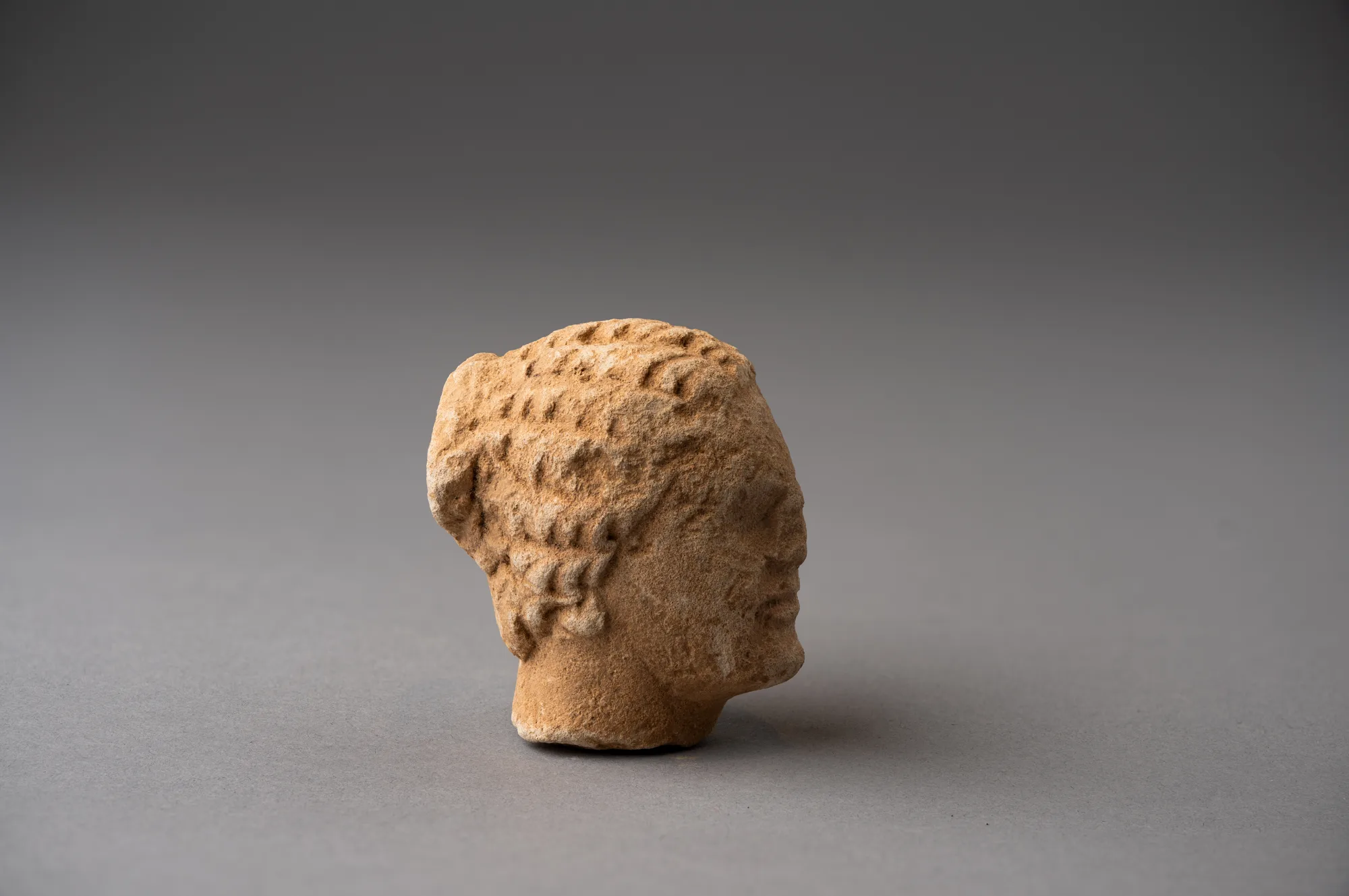 Limestone Head of a Boy, probably from a Temple Boy Statuette, Classical Cypriot