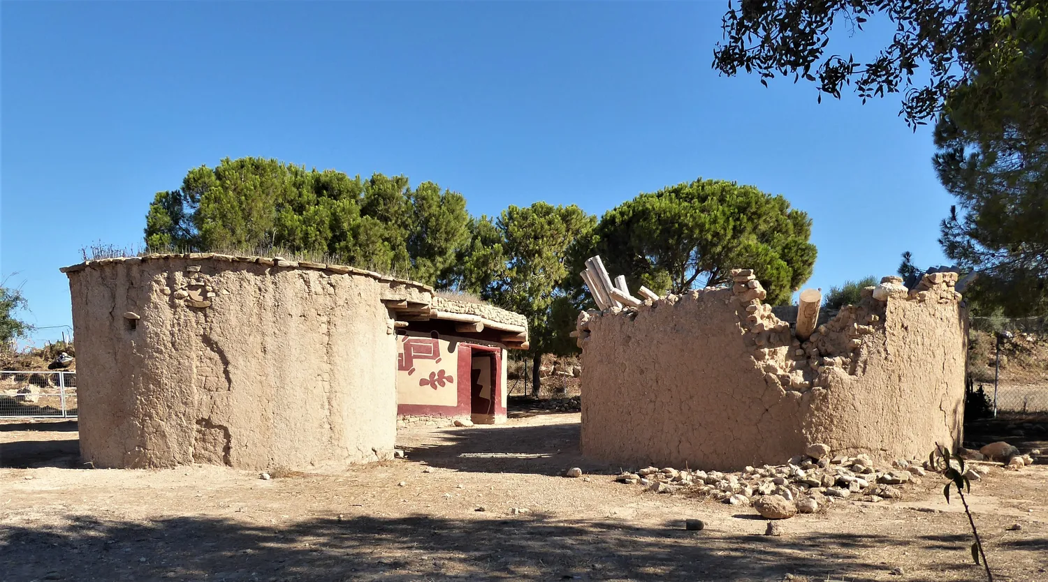 Round houses at the Lemba Experimental Village near Paphos, built by archaeologists on the evidence of the Chalcolithic houses excavated beside them. The house on the right has lost its roof, and its mud walls, with stones bedded in them, are crumbling back to earth. Photo: Chris06, CC BY-SA 4.0.